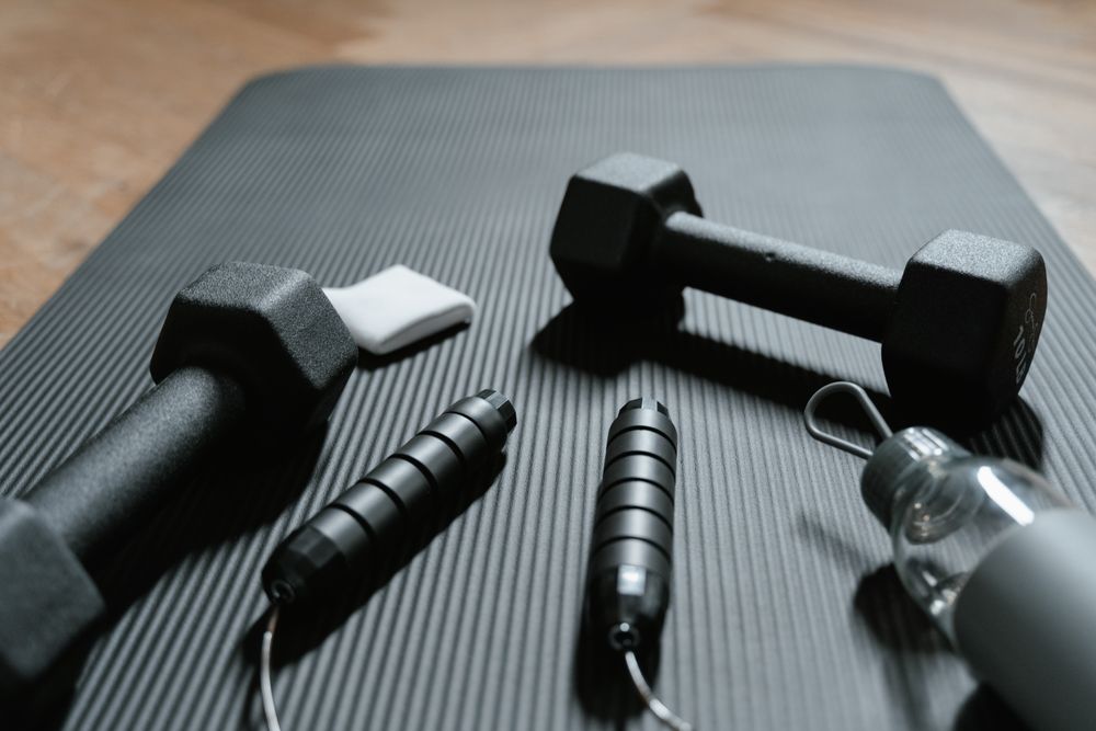 Pair of black hex dumbbells on an exercise mat